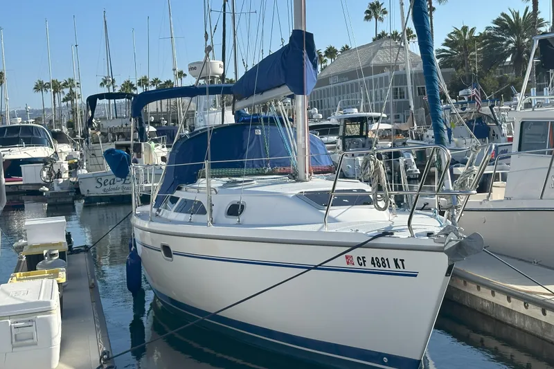 Slide: The Image of Catalina 28 MkII sailboat, 2001 model, docked in a marina with palm trees. - 8