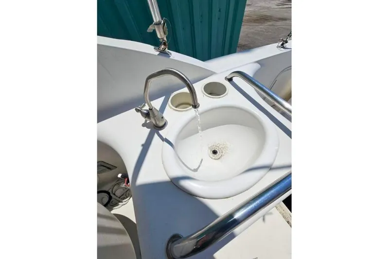 Slide: The Image of 2001 Sea Ray 260 Sundancer boat sink with running water and stainless steel fixtures. - 10