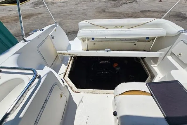 Slide: The Image of 2001 Sea Ray 260 Sundancer boat interior with open engine compartment. - 11