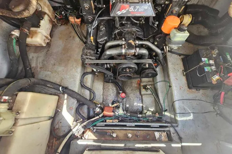 Slide: The Image of Engine compartment of a 2001 Sea Ray 260 Sundancer boat, featuring a 5.7L engine. - 12