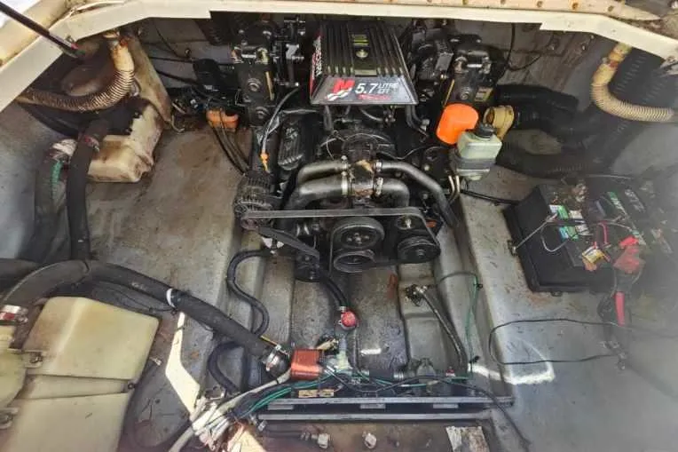 Slide: The Image of Engine compartment of a 2001 Sea Ray 260 Sundancer boat, featuring a 5.7L engine. - 14