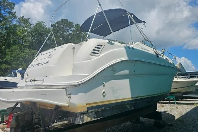 Slide: The Image of 2001 Sea Ray 260 Sundancer boat on dry dock under a blue sky. - 2