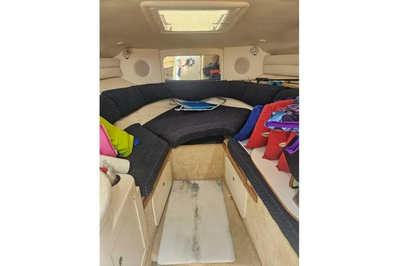 Slide: The Image of Interior of 2001 Sea Ray 260 Sundancer boat with cozy seating and colorful cushions. - 20
