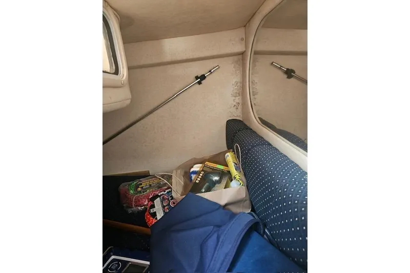 Slide: The Image of Interior cabin of 2001 Sea Ray 260 Sundancer with storage items and seating. - 21