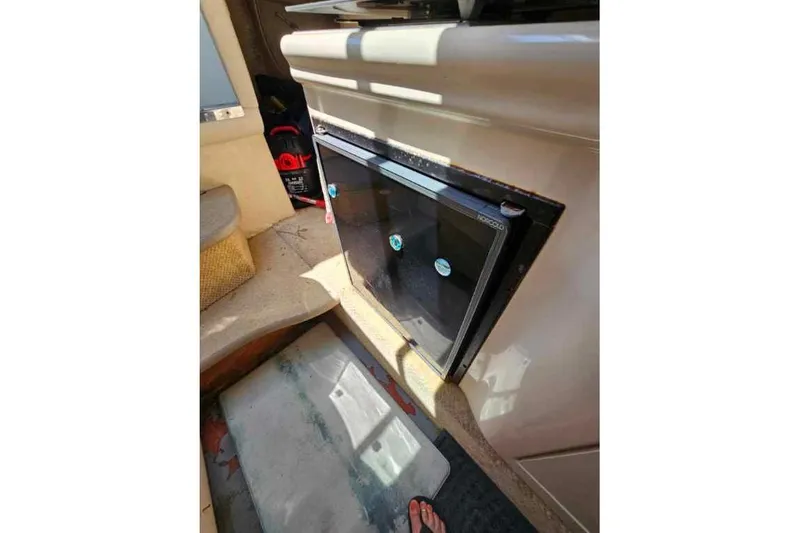 Slide: The Image of Interior of 2001 Sea Ray 260 Sundancer showing compact cabin refrigerator. - 28