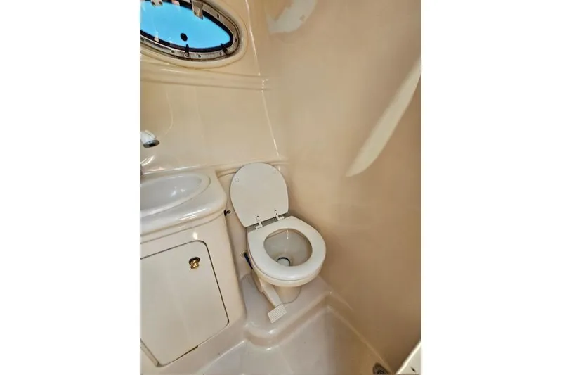 Slide: The Image of 2001 Sea Ray 260 Sundancer boat bathroom with toilet and sink. - 30