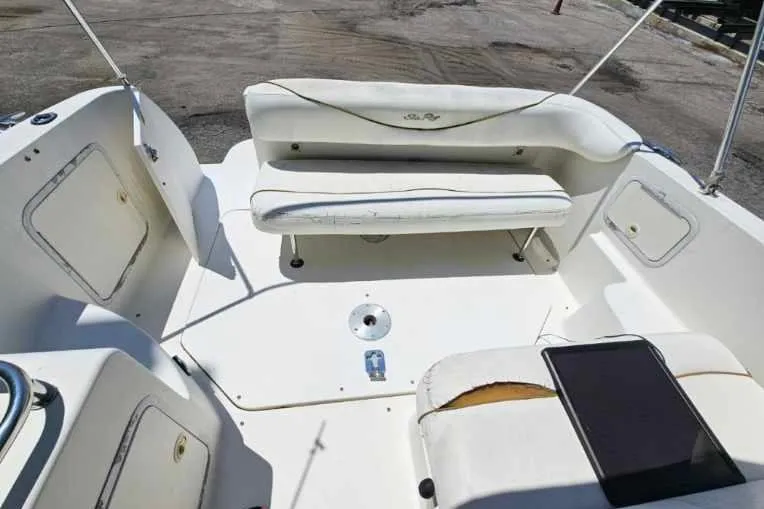 Slide: The Image of 2001 Sea Ray 260 Sundancer boat interior with white seating and storage compartments. - 36