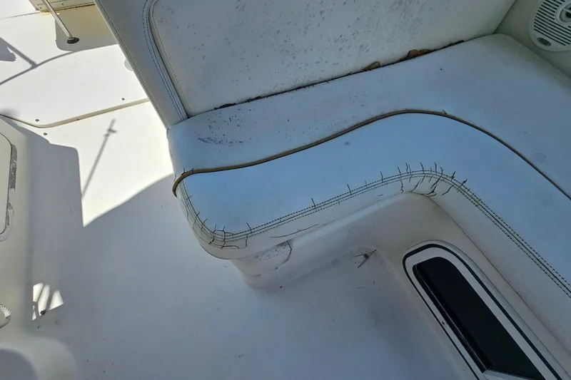 Slide: The Image of Worn seating on 2001 Sea Ray 260 Sundancer boat, showing visible stitching and wear. - 37