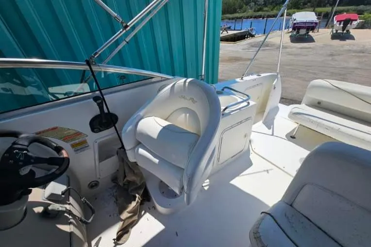 Slide: The Image of 2001 Sea Ray 260 Sundancer boat interior with white seating and steering wheel. - 39