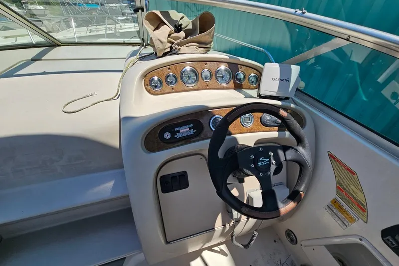 Slide: The Image of 2001 Sea Ray 260 Sundancer helm with Garmin GPS and wood-accented dashboard. - 40