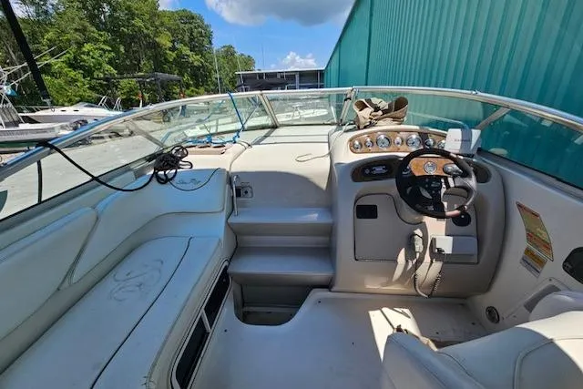 Slide: The Image of 2001 Sea Ray 260 Sundancer boat interior with steering wheel and seating area. - 41