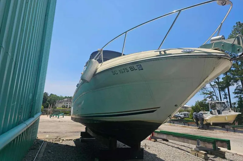 Slide: The Image of 2001 Sea Ray 260 Sundancer boat on dry dock under clear blue sky. - 5