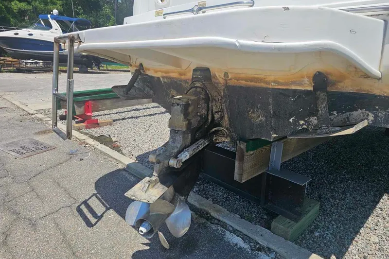Slide: The Image of 2001 Sea Ray 260 Sundancer boat on dry dock, showing stern and propeller. - 7