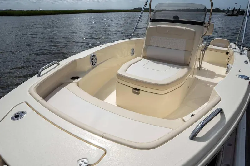 Slide: The Image of Manufacturer Provided Image: 2026 Scout 188 Sportfish boat interior with seating, on a calm waterway. - 7