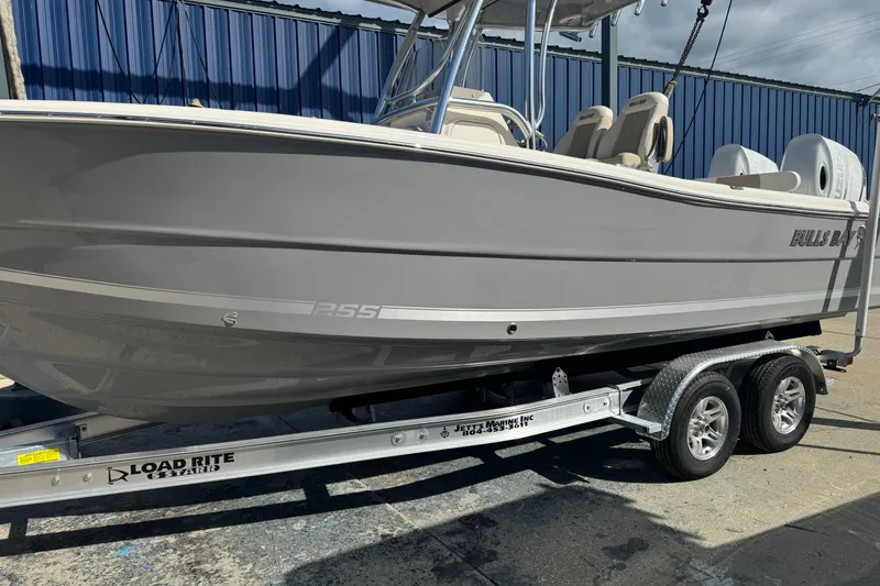 Slide: The Image of 2026 Bulls Bay 255 boat on Load Rite trailer, parked outdoors. - 1