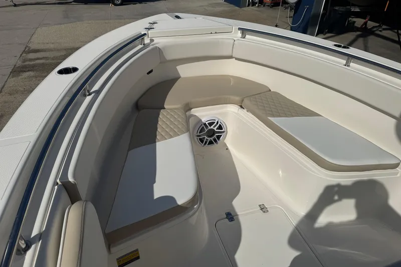 Slide: The Image of 2026 Bulls Bay 255 boat interior with cushioned seating and speaker system. - 12