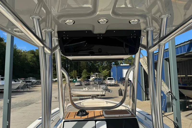 Slide: The Image of 2026 Bulls Bay 255 boat with T-top and console, docked at a marina. - 9