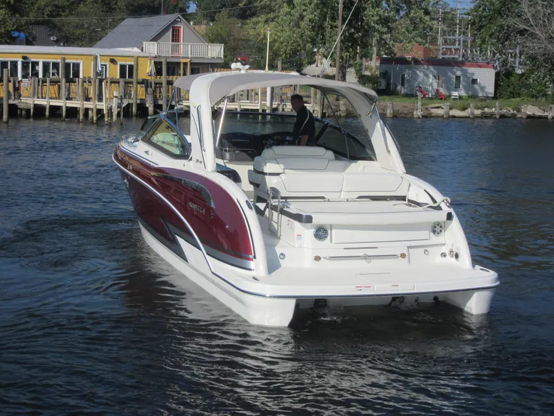 Slide: The Image of 2019 Formula 350 Crossover Bowrider on a calm lake near a dock. - 3