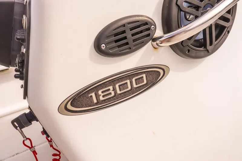 Slide: The Image of Key Largo 1800 Center Console boat detail, featuring model emblem and speaker, 2020. - 9