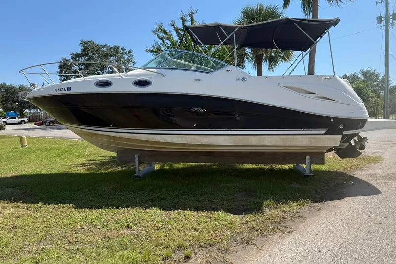 The Image of 2006 Sea Ray 270 Amberjack boat on display, featuring sleek design and black hull. - 0