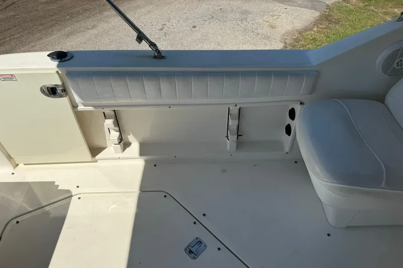 Slide: The Image of 2006 Sea Ray 270 Amberjack boat interior with white seating and storage compartments. - 14