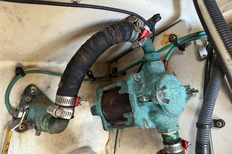 Slide: The Image of Engine component of a 2006 Sea Ray 270 Amberjack boat, showing hoses and clamps. - 19