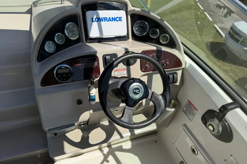 Slide: The Image of 2006 Sea Ray 270 Amberjack helm with Lowrance display and steering wheel. - 2