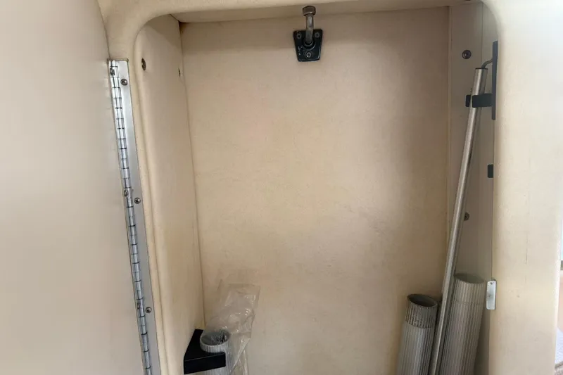 Slide: The Image of 2006 Sea Ray 270 Amberjack interior storage compartment with hooks and rods. - 28