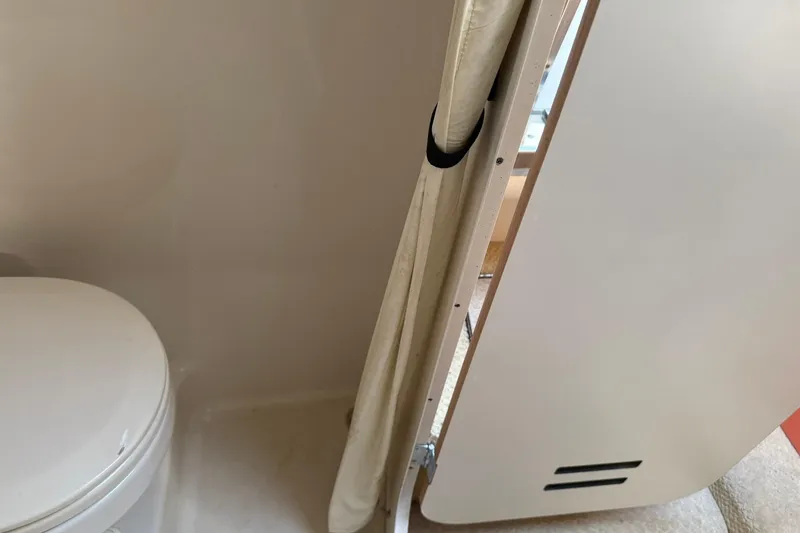 Slide: The Image of Interior of 2006 Sea Ray 270 Amberjack boat showing compact bathroom space. - 30