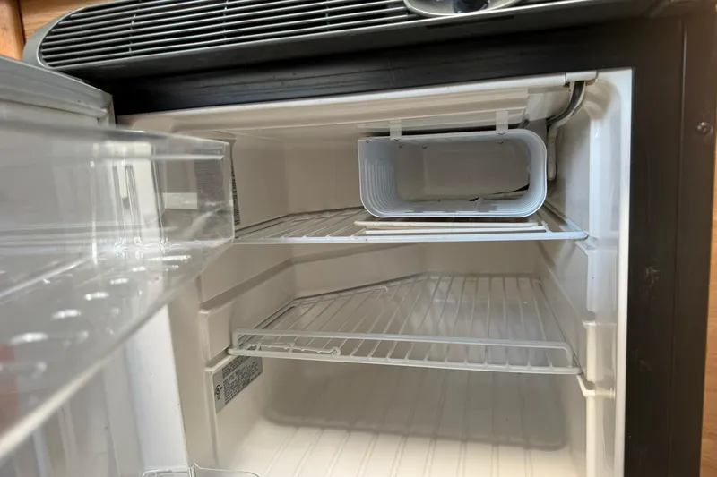 Slide: The Image of Empty refrigerator interior on a 2006 Sea Ray 270 Amberjack boat. - 37