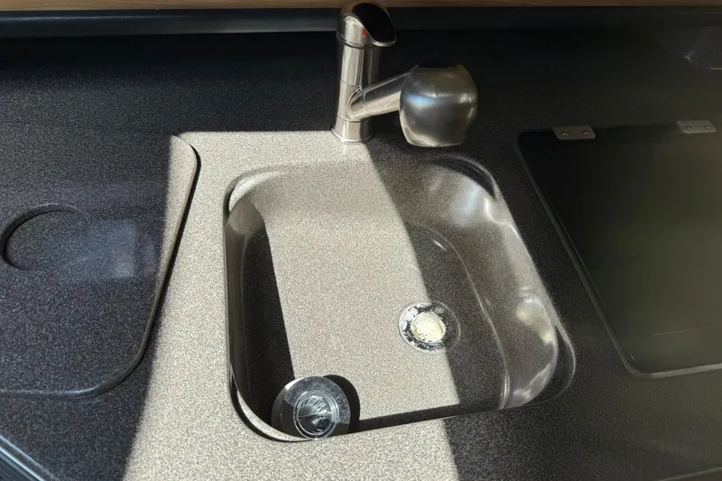 Slide: The Image of 2006 Sea Ray 270 Amberjack kitchen sink with modern faucet and countertop. - 38