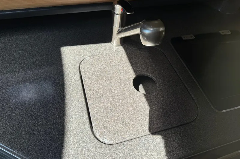 Slide: The Image of 2006 Sea Ray 270 Amberjack kitchen sink with modern faucet and cover. - 39