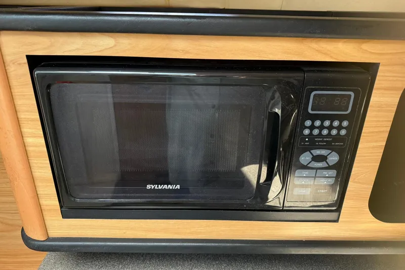 Slide: The Image of Sylvania microwave in 2006 Sea Ray 270 Amberjack boat kitchen setup. - 40