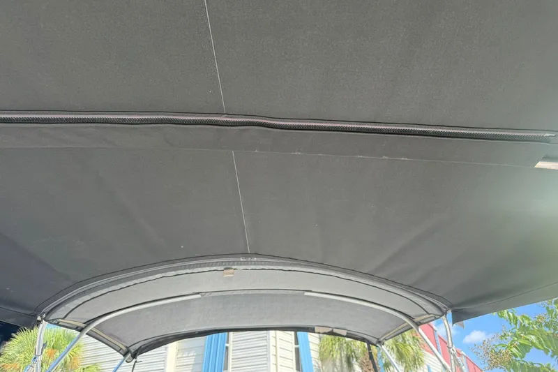 Slide: The Image of Bimini top of 2006 Sea Ray 270 Amberjack boat under sunny sky. - 44