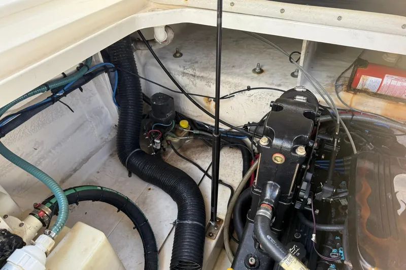 Slide: The Image of Engine compartment of a 2006 Sea Ray 270 Amberjack boat, showing hoses and components. - 46