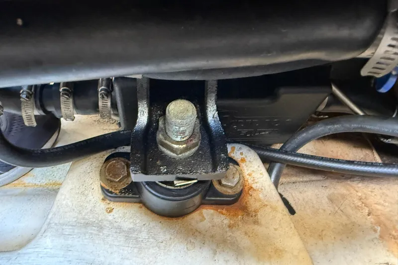 Slide: The Image of Engine mount detail of 2006 Sea Ray 270 Amberjack boat, showing bolts and hoses. - 49