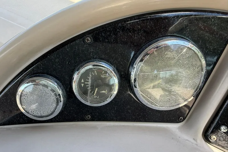 Slide: The Image of Dashboard gauges of a 2006 Sea Ray 270 Amberjack boat, showing wear and condensation. - 50
