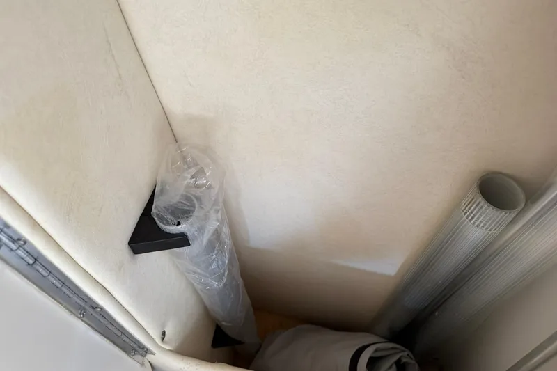 Slide: The Image of Storage area inside 2006 Sea Ray 270 Amberjack boat with rolled materials. - 54