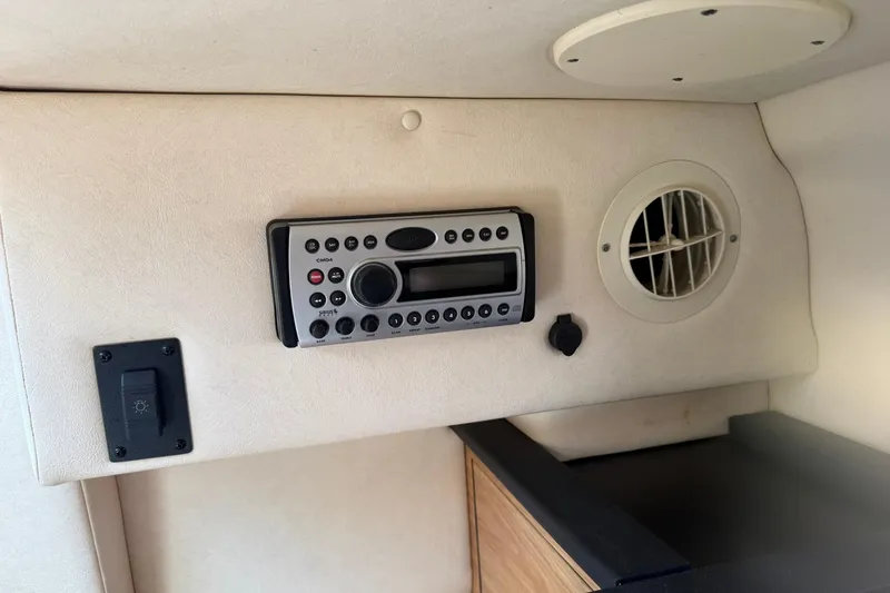 Slide: The Image of 2006 Sea Ray 270 Amberjack cabin interior with stereo system and air vent. - 55