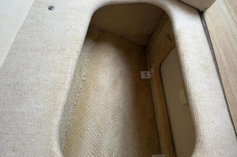 Slide: The Image of Carpeted storage compartment in 2006 Sea Ray 270 Amberjack boat interior. - 58