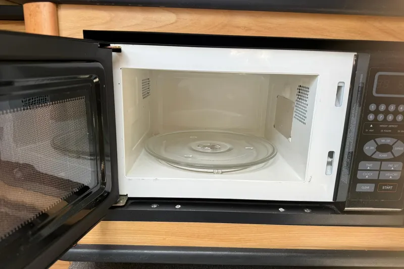 Slide: The Image of Open microwave inside a 2006 Sea Ray 270 Amberjack boat kitchen area. - 61