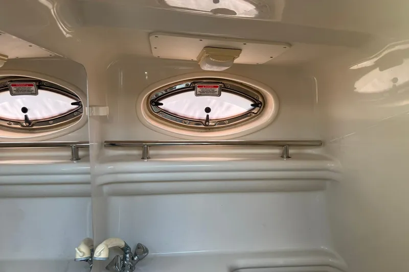 Slide: The Image of Interior of 2006 Sea Ray 270 Amberjack boat with oval windows and stainless steel rail. - 69