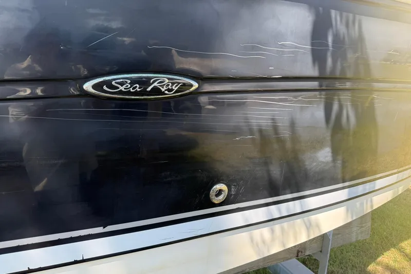 Slide: The Image of 2006 Sea Ray 270 Amberjack boat hull with scratches and logo visible. - 70