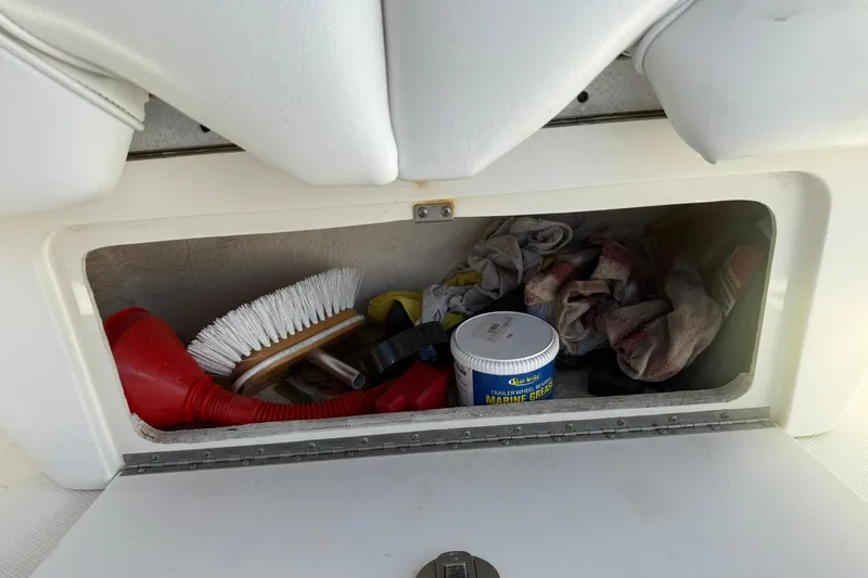 Slide: The Image of Storage compartment on a 2006 Sea Ray 270 Amberjack with cleaning supplies and tools. - 72