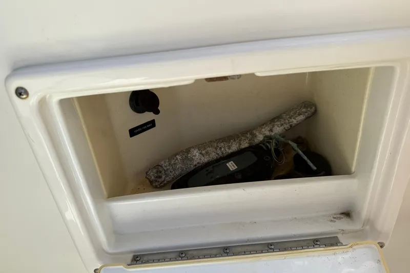 Slide: The Image of Storage compartment on a 2006 Sea Ray 270 Amberjack boat, containing various items. - 74