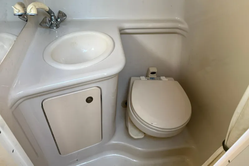 Slide: The Image of Compact bathroom in 2006 Sea Ray 270 Amberjack boat, featuring sink and toilet. - 8