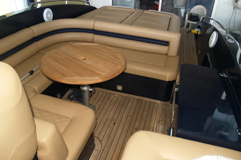 Slide: The Image of Luxurious interior of 2012 Hunton XRS 43 with tan leather seating and wooden table. - 3