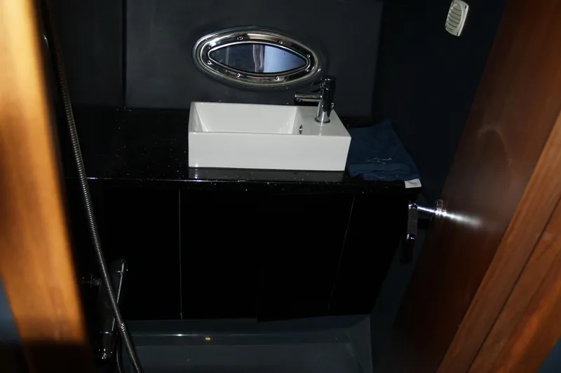 Slide: The Image of Interior of 2012 Hunton XRS 43 yacht bathroom with modern sink and porthole window. - 7