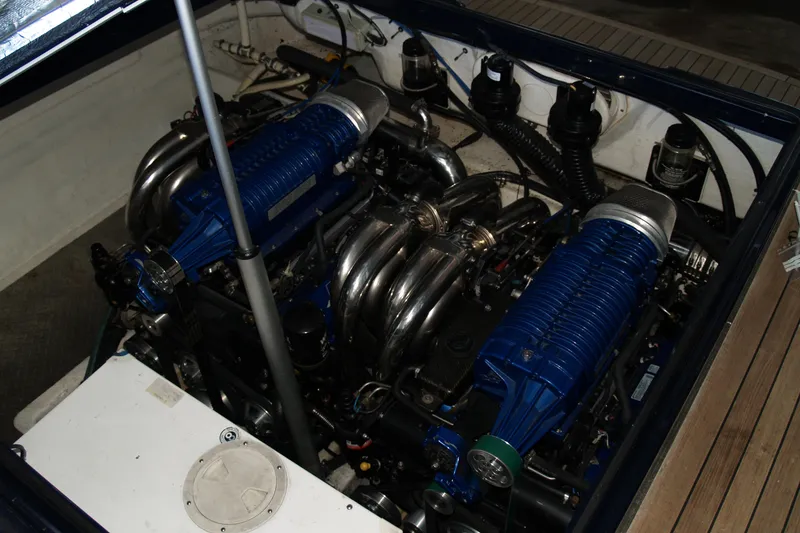 Slide: The Image of Engine compartment of a 2012 Hunton XRS 43 boat, showcasing dual blue engines. - 9