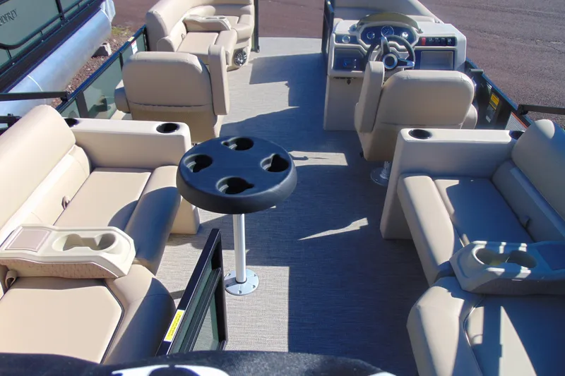 Slide: The Image of 2026 Godfrey Xperience 2086SBX pontoon boat interior with beige seating and cup holders. - 13